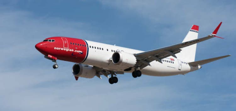 Tenerife, Spain January 13 st, 2024. Boeing 737 MAX 8 Norwegian Airlines flies in the blue sky