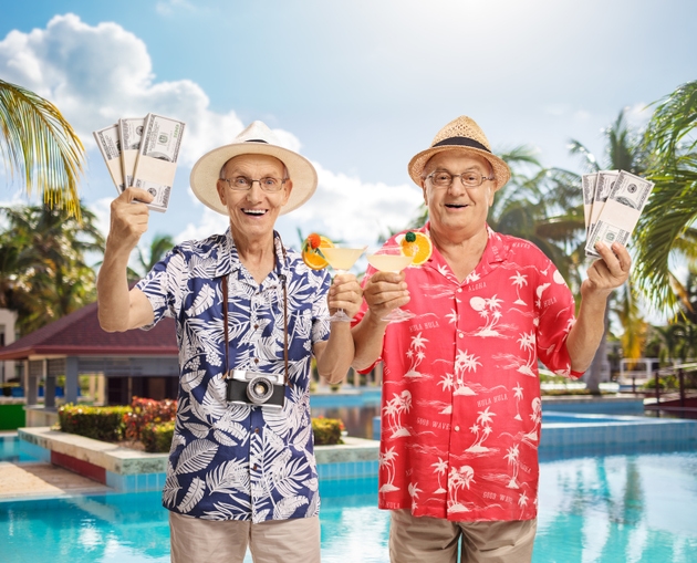 Elderly tourists with cocktails and cash