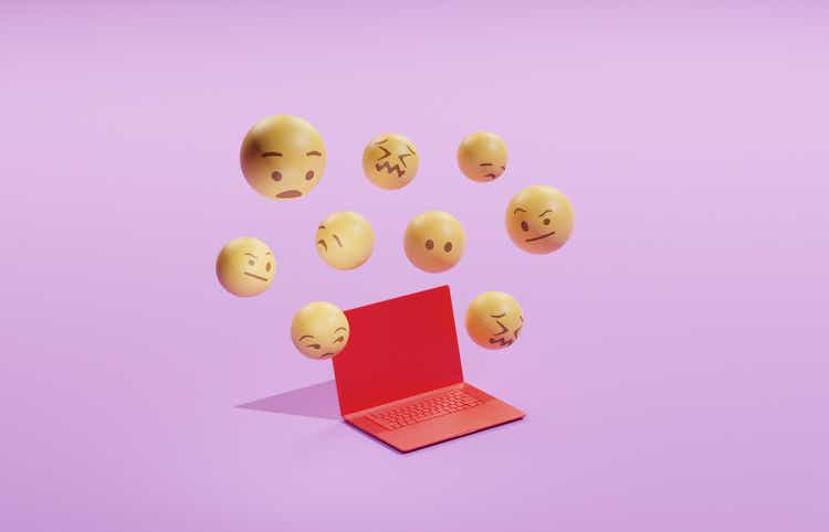 Emojis hovering over a laptop