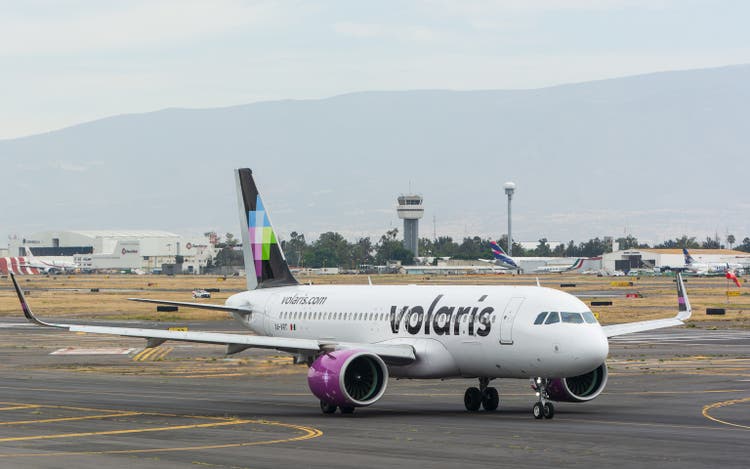 Passenger Volaris plane parked on an airport runway