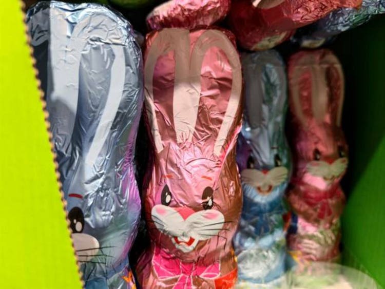 Chocolate Easter bunnies in pink and blue packaging are on supermarket shelves and are ready to be sold for Easter