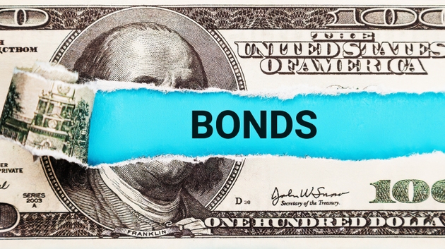 Bonds. The word Bonds in the background of the US dollar. Fixed Income Investment, Government Bonds, and Financial Security Concept.