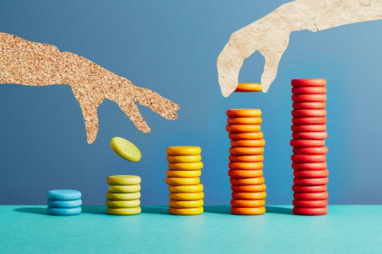 Hands putting coins on stacks