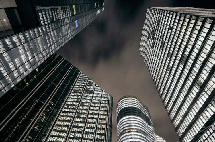 Illuminated office facades at modern business district at dusk