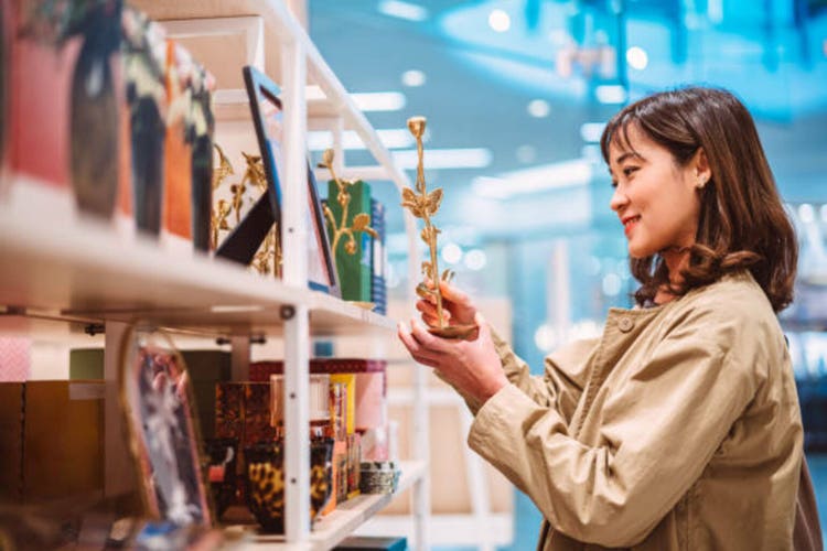 Beautiful Asian woman shopping for home decor in a life style store in shopping mall