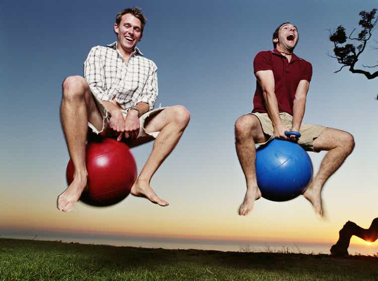 Two young men playing with bounce and hop balls