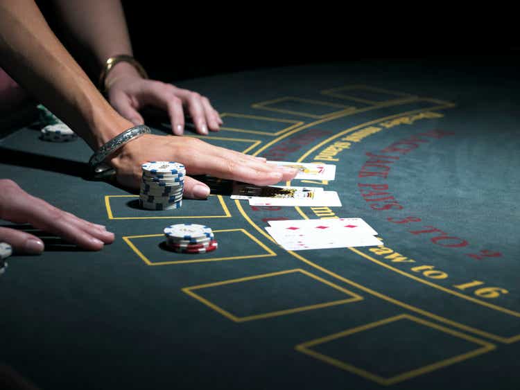 Two women playing Blackjack at gaming table, close-up