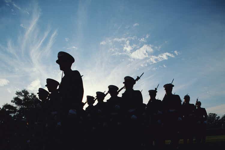 Silhouetted naval cadets marching in formation, low angle view