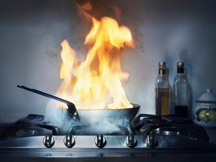 Burning frying pan in kitchen