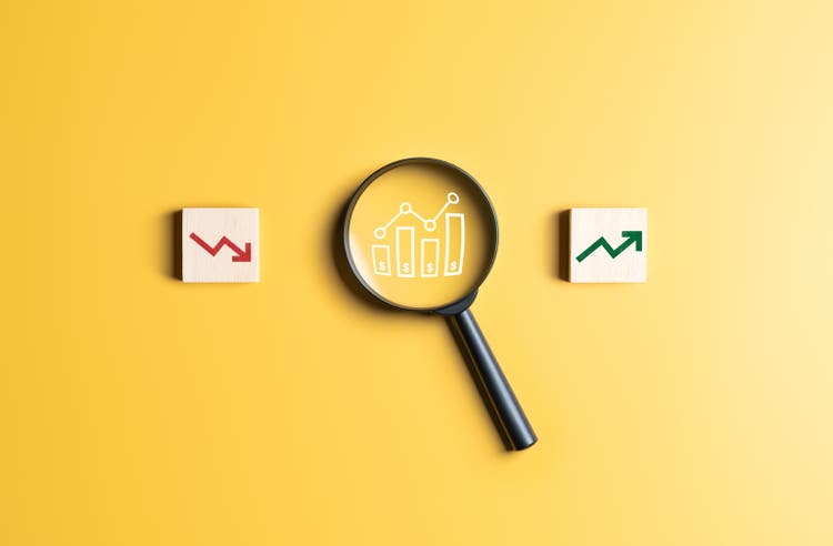 Economic inflation, world financial crisis, global economic recession, stock market crash, increasing interest concepts. Magnifier with financial graph chart and falling and rise arrow icons on label.