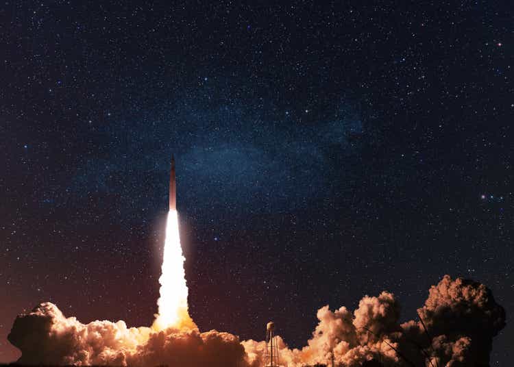 A modern space rocket with noise and smoke successfully takes off into the starry space in the dark.  A new spaceship has risen, flying on a space mission