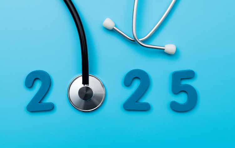 Stethoscope and number 2025 on blue background