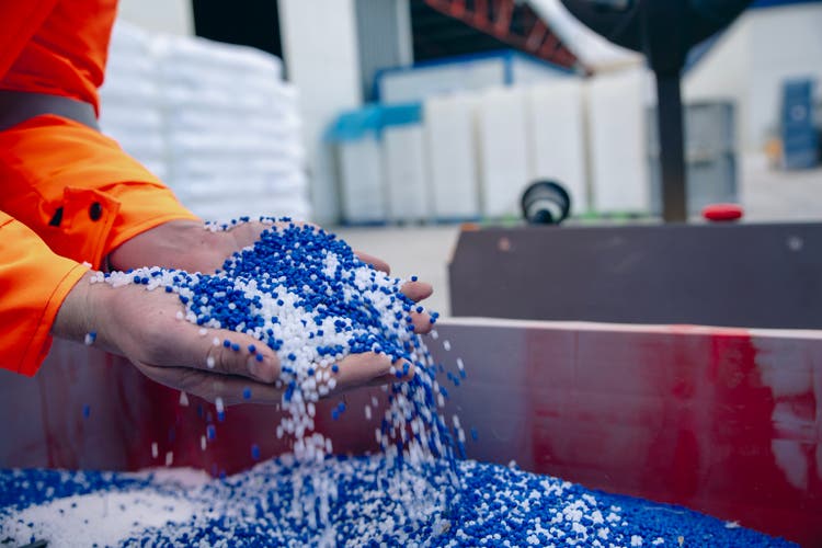 Plastic granules are poured from the hand