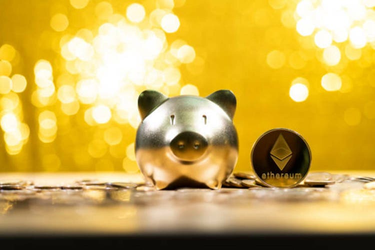 Ethereum cryptocurrency and piggy bank on shiny background
