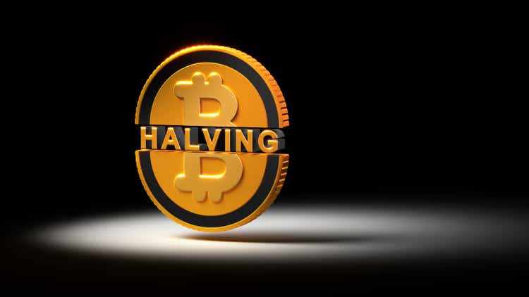Bitcoin halving. Golden coin with bitcoin sign cut in half with dramatic lighting