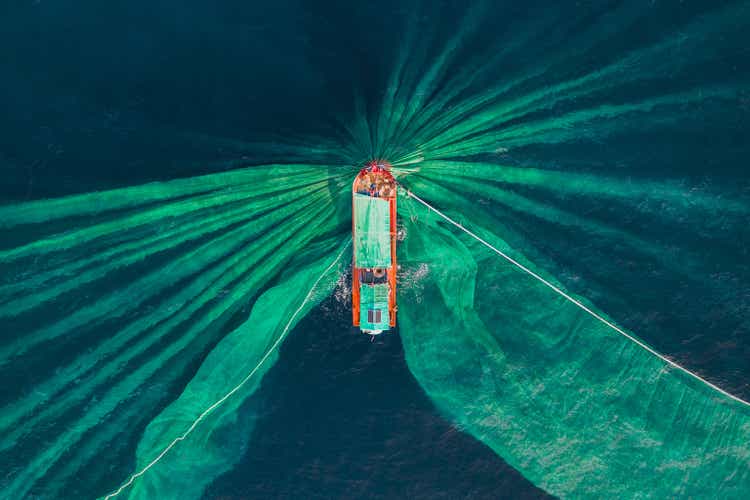 Drone photograph looking down on a fishing trawler catching anchovies, Vietnam