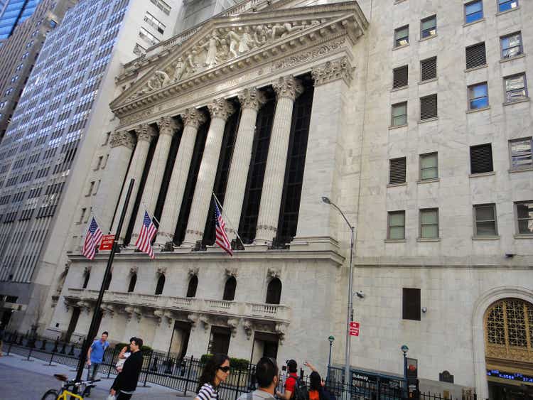 Pedestrians pass by the iconic New York Stock Exchange building