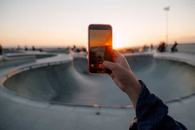 Woman capturing golden hour light at the skate park