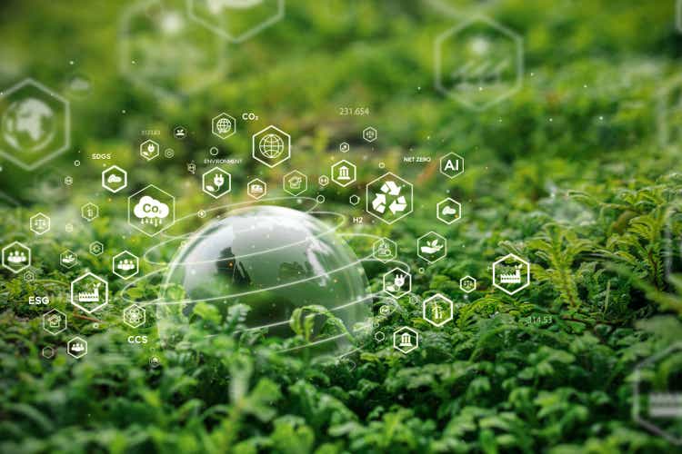 Crystal ball on moss in green forest forest Environmental concept, ecology and sustainable environment of the world. Icons scattered around green globe