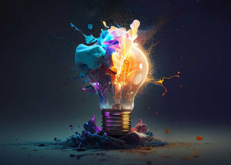 Creative light bulb explodes with colorful paint and splashes on a black background. Think differently creative idea concept