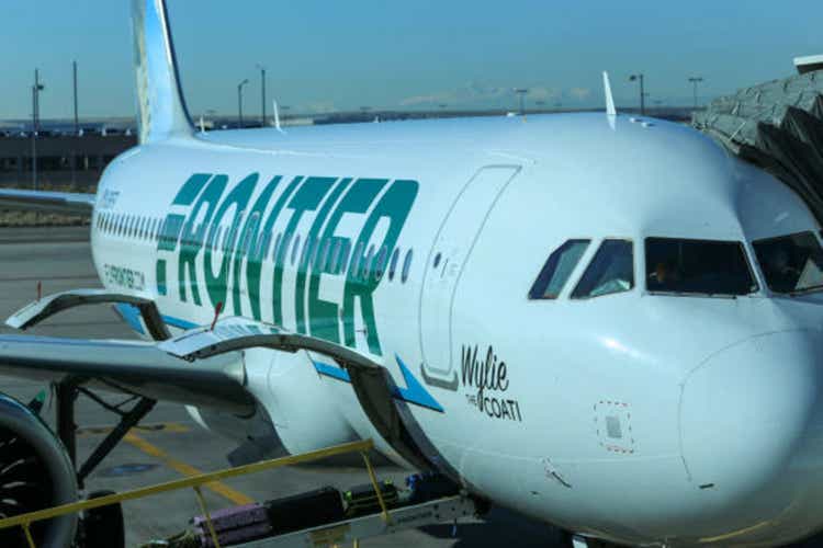 Frontier Airlines Jet Airline at gate in daytime