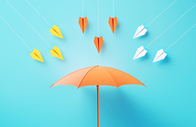 Paper Planes Flying Towards A Coral Colored Umbrella On Blue Background