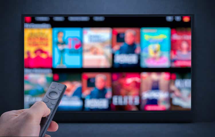 Tv online. Television streaming video. Male hand holding TV remote control. Multimedia streaming concept. VoD content provider. Video service with internet streaming multimedia shows, series.