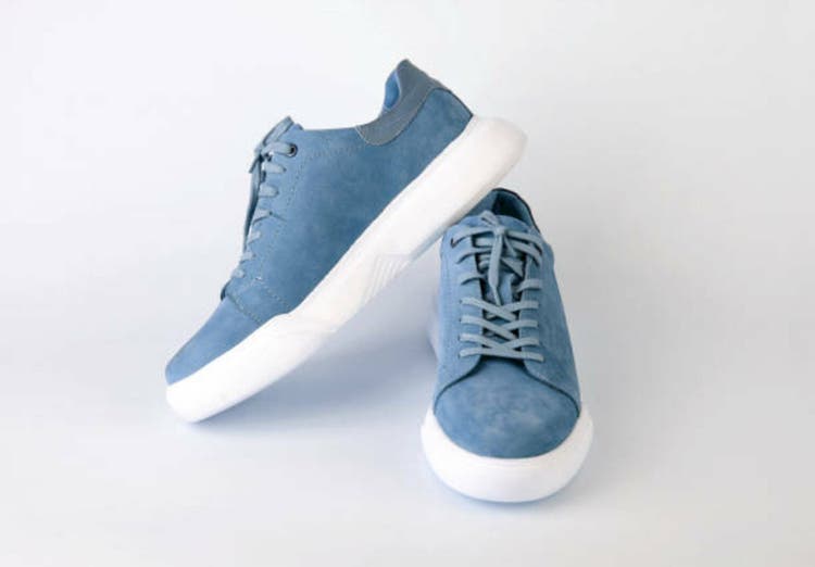 Pair of comfortable suede shoes on white background