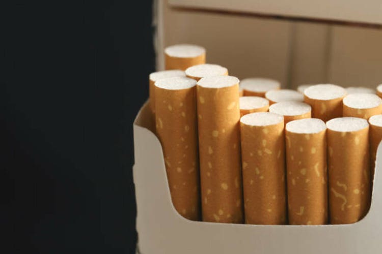 peel it off Cigarette pack prepare smoking on white wooden background. Packing line up. photo filters Natural light