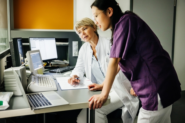 A Female Doctore and Medical Technician Discussing CT-Scan