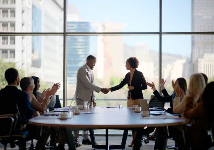 Meeting, handshake and business people in office for interview, welcome applause or onboarding for collaboration. Men, women and shaking hands in conference room for agreement, consulting or b2b deal