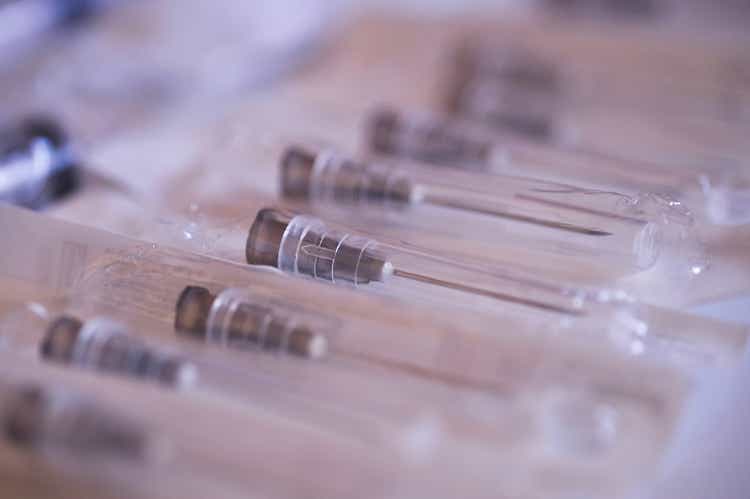 syringes over white surface, for medical, healthcare or pharmacy themes