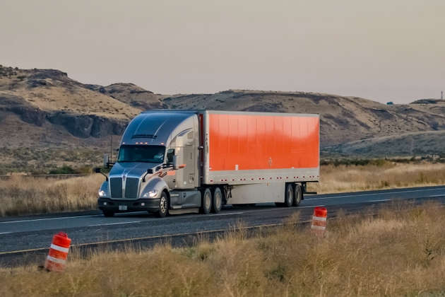 Schneider National trucking company semi-truck traveling on highway US-395, near Pasco, Washington in September 2019.