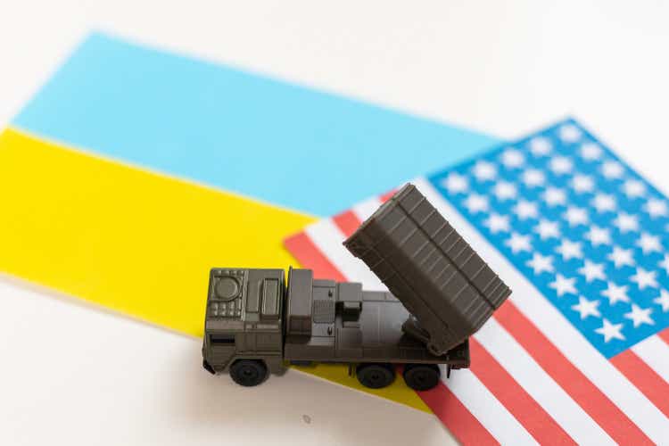 military vehicle and flags of the USA and Ukraine. Defeat of Russia in war in Ukraine concept