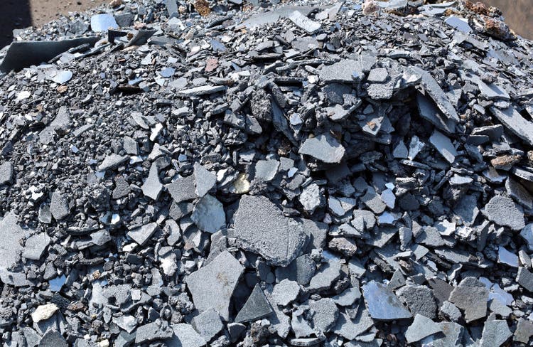 Heap of steel slags and iron lumps from metallurgical industry ready for recycling.
