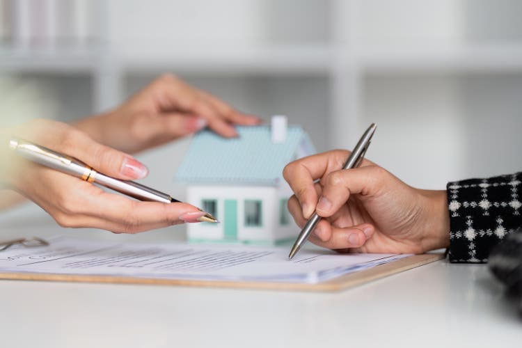 Real estate agent offer hand for customer sign agreement contract signature for buy or sell house. Real estate concept contact agreement concept