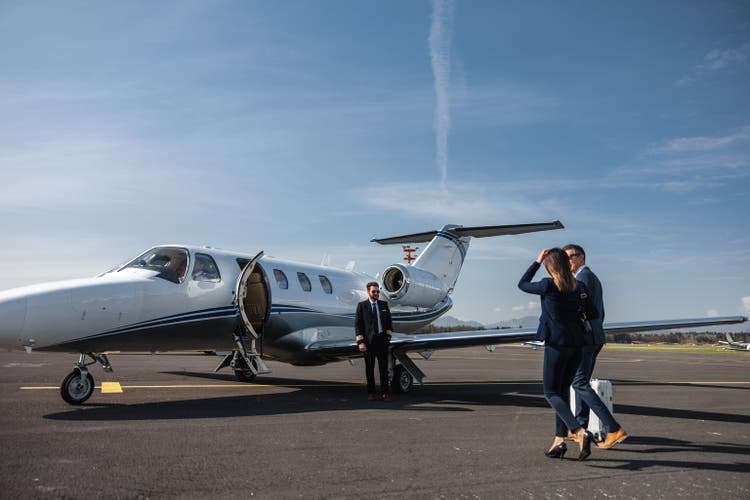 Business Executives Walking Toward Private Jet for Travel