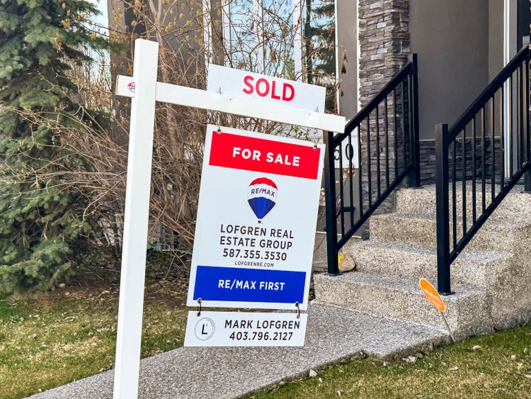 A Remax Real Estate sign during spring.