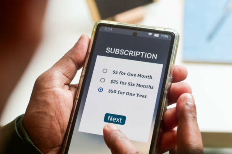 Man choosing a annual subscription plan using mobile applications for newspaper or delivery or online streaming service.