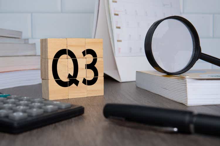 Close up image of wooden cubes with alphabet Q3 on office desk.