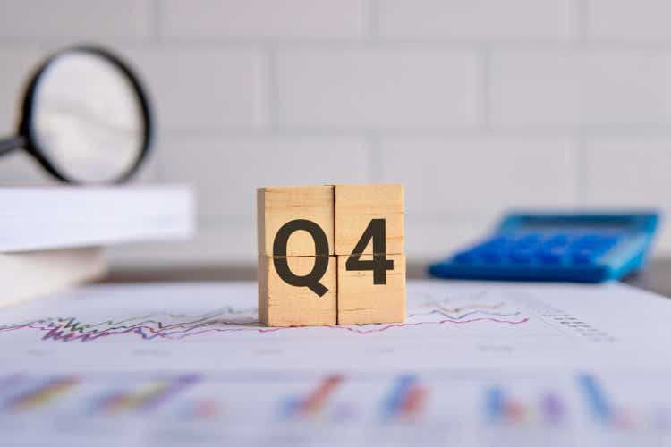 Close up image of wooden cubes with alphabet Q4 on office desk.