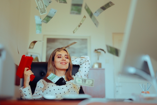 Manager with Money Gun Sitting in the Office Being Carefree