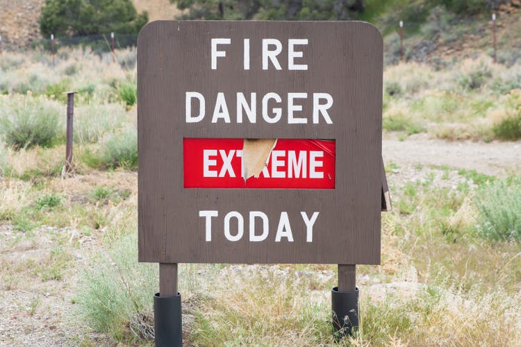 Weathered "Fire Danger Extreme Today" Sign in Desert