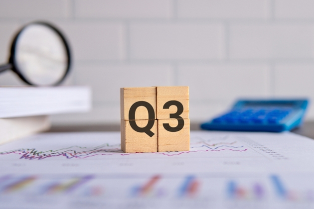 Close up image of wooden cubes with alphabet Q3 on office desk.