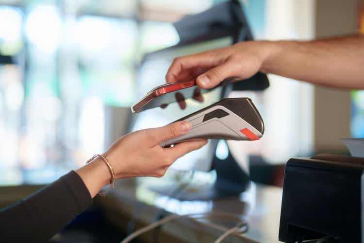 A close-up of a smartphone being used for contactless payment.