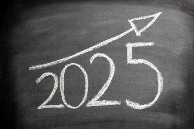 2025 with ascending arrow on blackboard