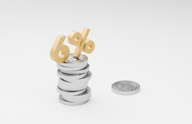 Stack of silver coins with 6 percent sign on top