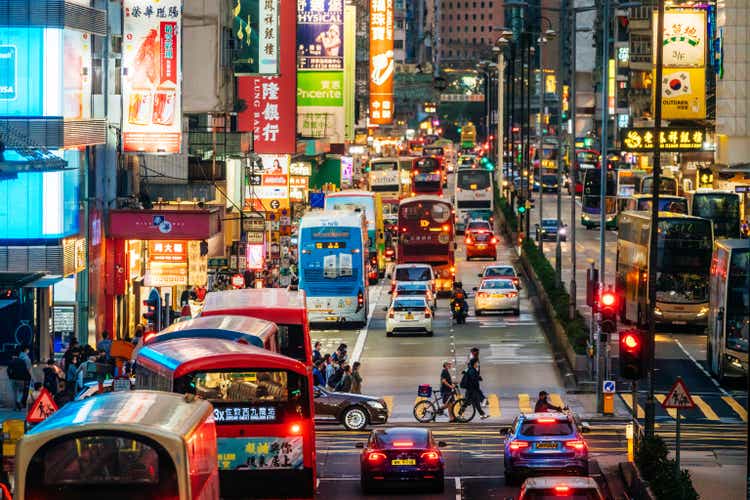 Pedestrians crossing street at night in Hong Kong, China