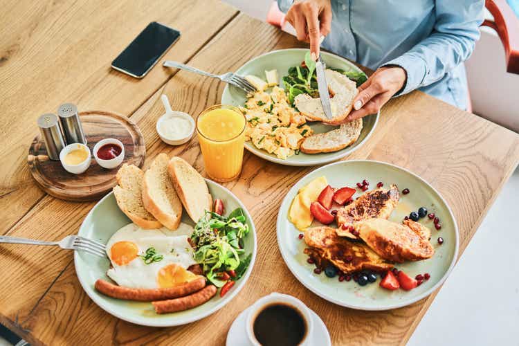 Close-up of a couple eating a delicious breakfast together in the restaurant