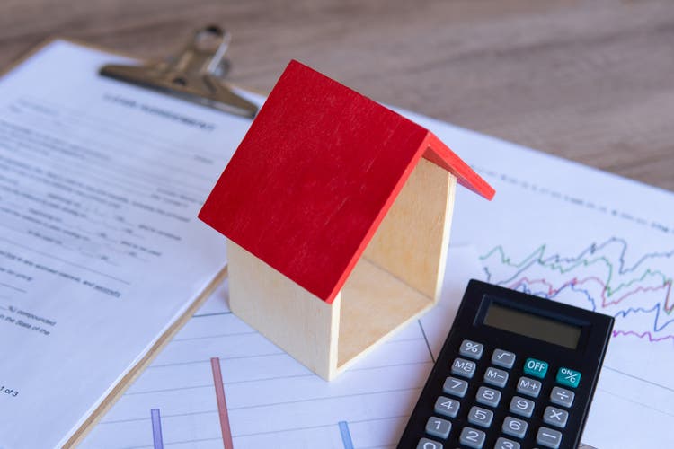 Wooden toy house, calculator and graph.